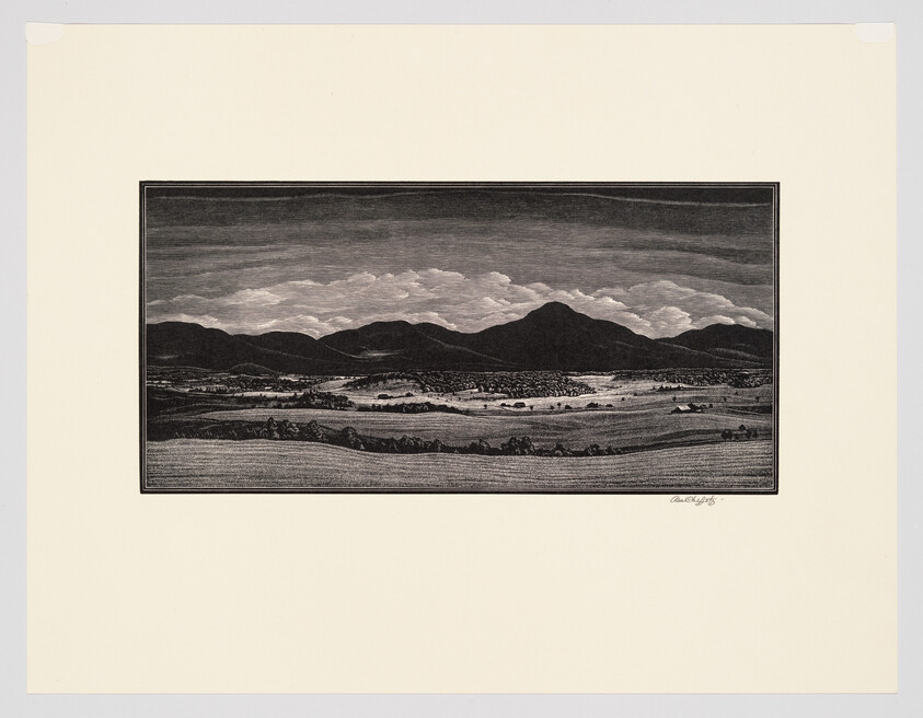 A black-and-white woodcut shows fields, a small town, and a mountain range under cloudy sky.