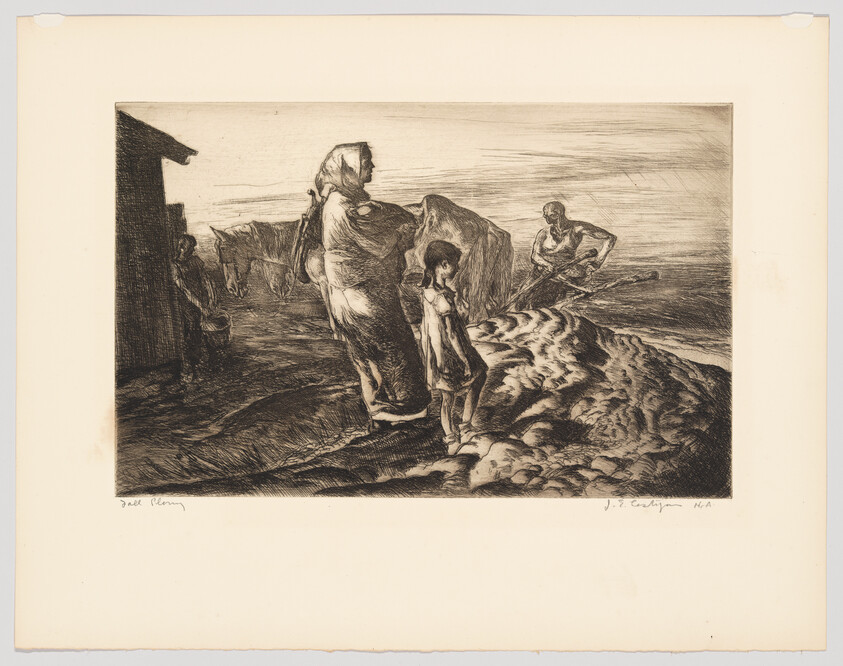 A mother and child stand on a windswept shore while a man digs in the sand.