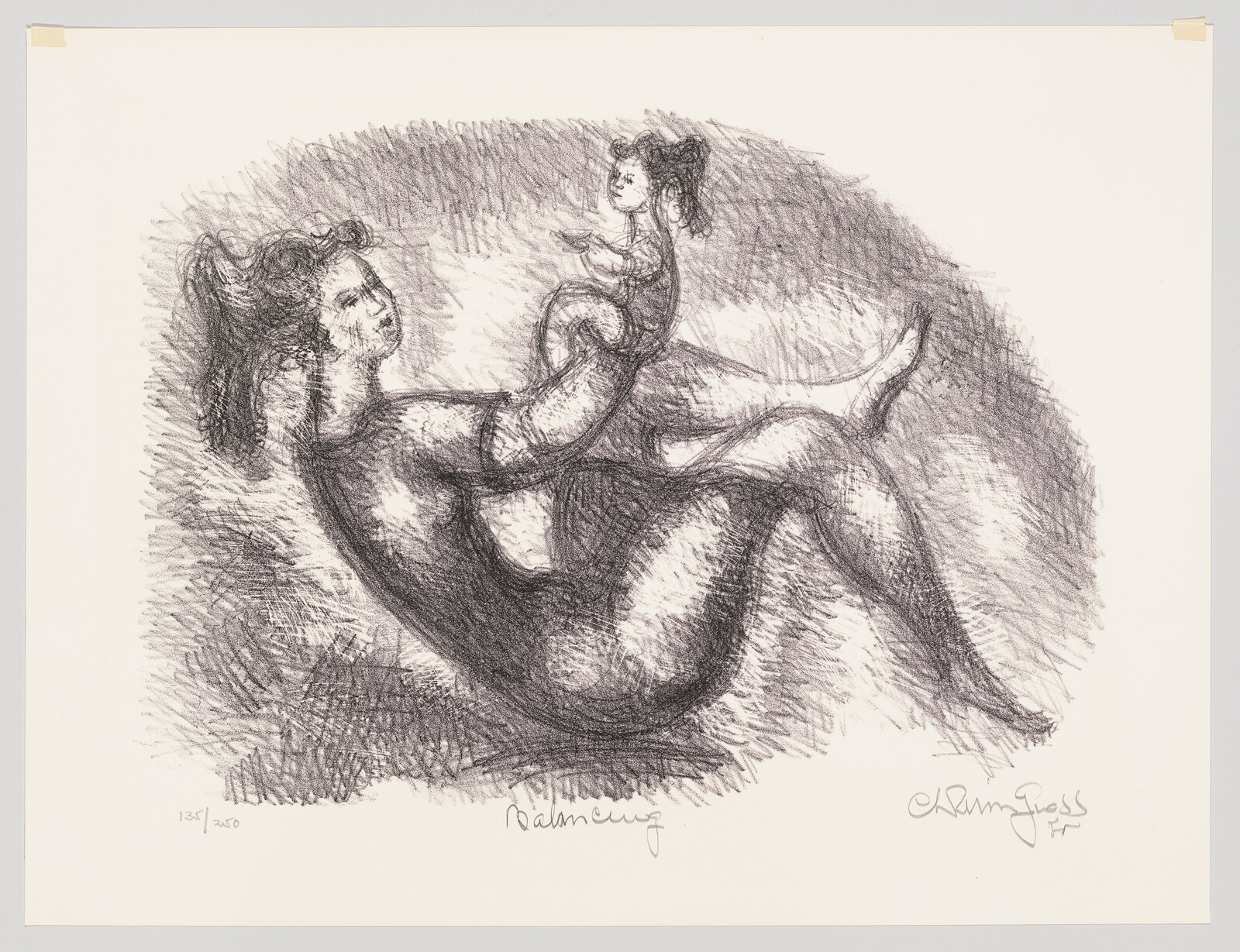 A woman balances a small child above her legs while lying on her back.