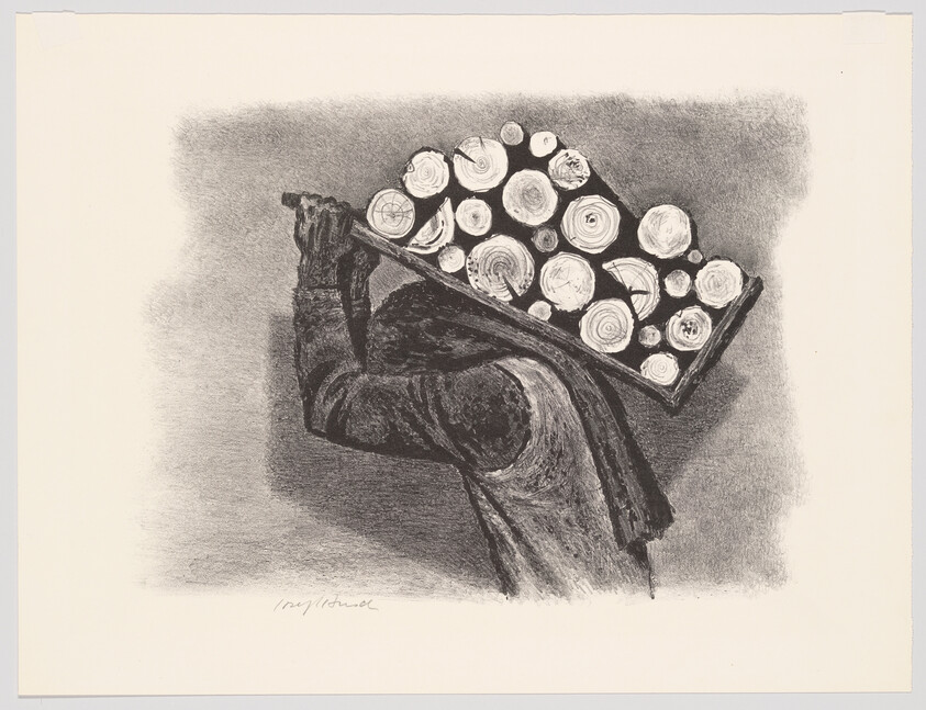 A person carries a heavy crate of cut logs on their shoulder while walking.