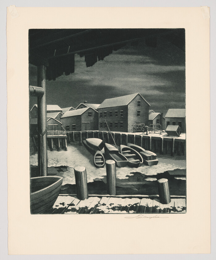 Small rowboats pulled up along a wooden dock in front of coastal warehouses under a cloudy sky.