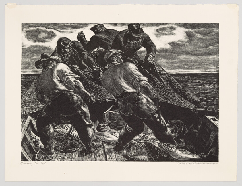 Five fishermen strain together on a small boat hauling a heavy fishing net filled with fish.