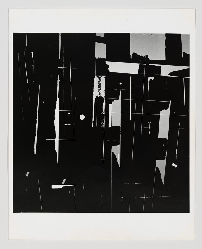 High-contrast abstract composition of black and white vertical panels, thin lines, and shapes.