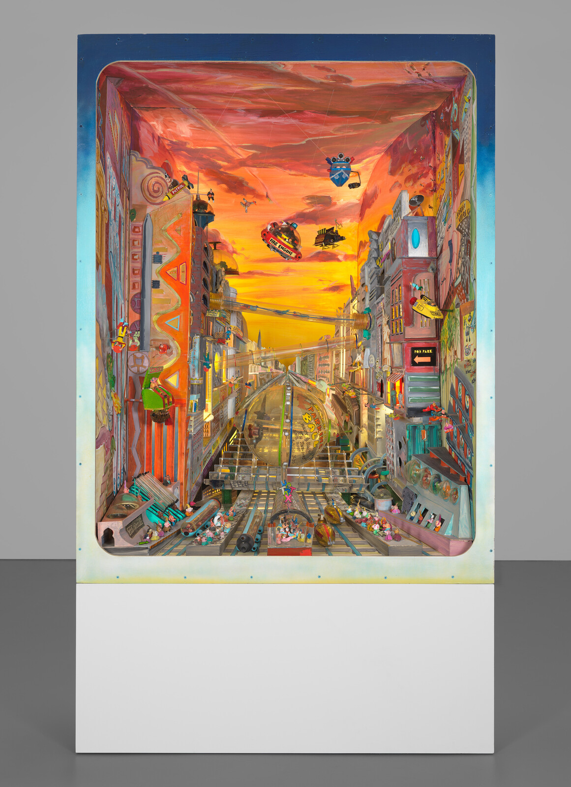 Colorful diorama of a busy futuristic city with flying cars, tall buildings, and a bright orange sky.