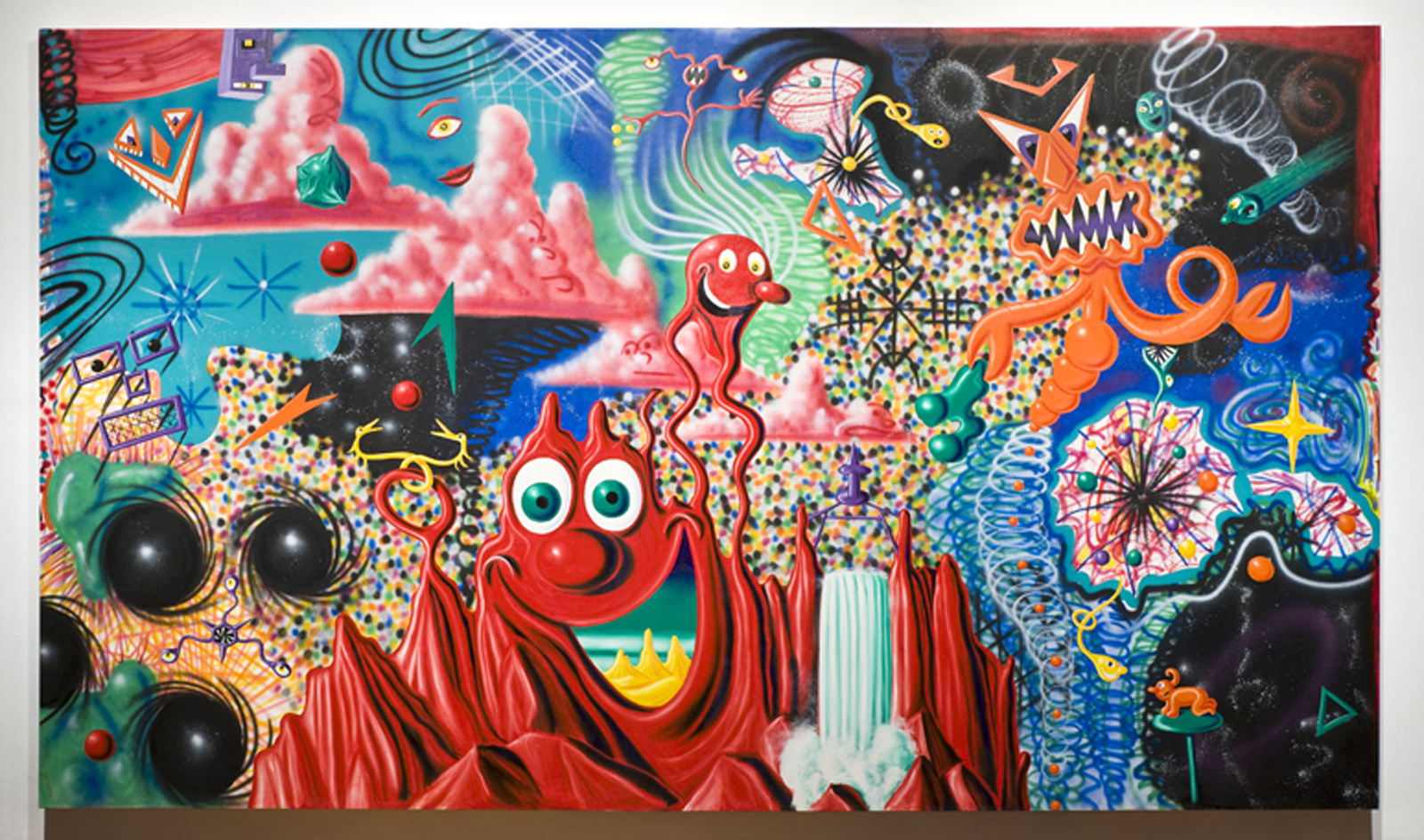 A vibrant and colorful abstract painting filled with various whimsical creatures, shapes, and patterns. The central figure is a red, cartoonish character with multiple eyes and a wide smile, surrounded by a chaotic landscape of mountains, clouds, and celestial bodies. The artwork features a mix of surreal elements, such as floating eyes, quirky animals, and playful geometric forms, all set against a backdrop that transitions from warm reds and oranges to cool blues and purples.