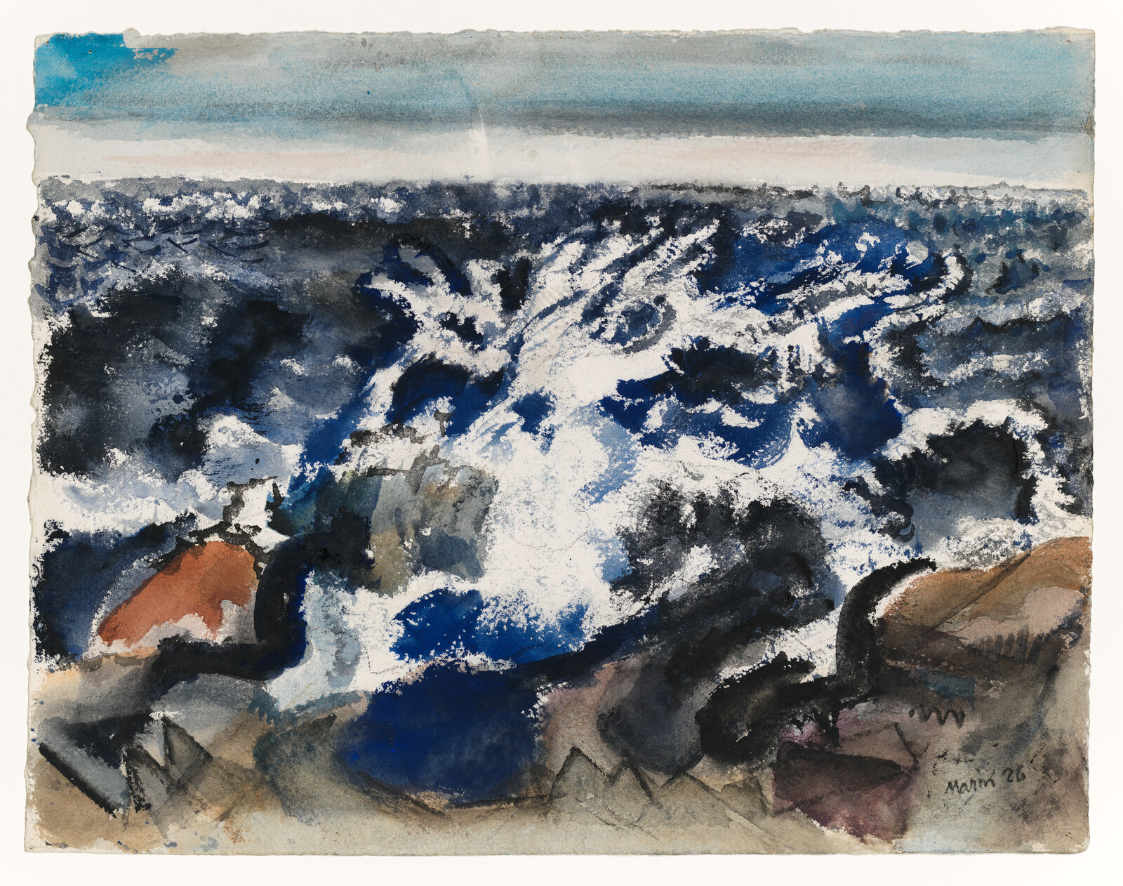 Powerful ocean waves crash against dark coastal rocks, sending white spray into the air.