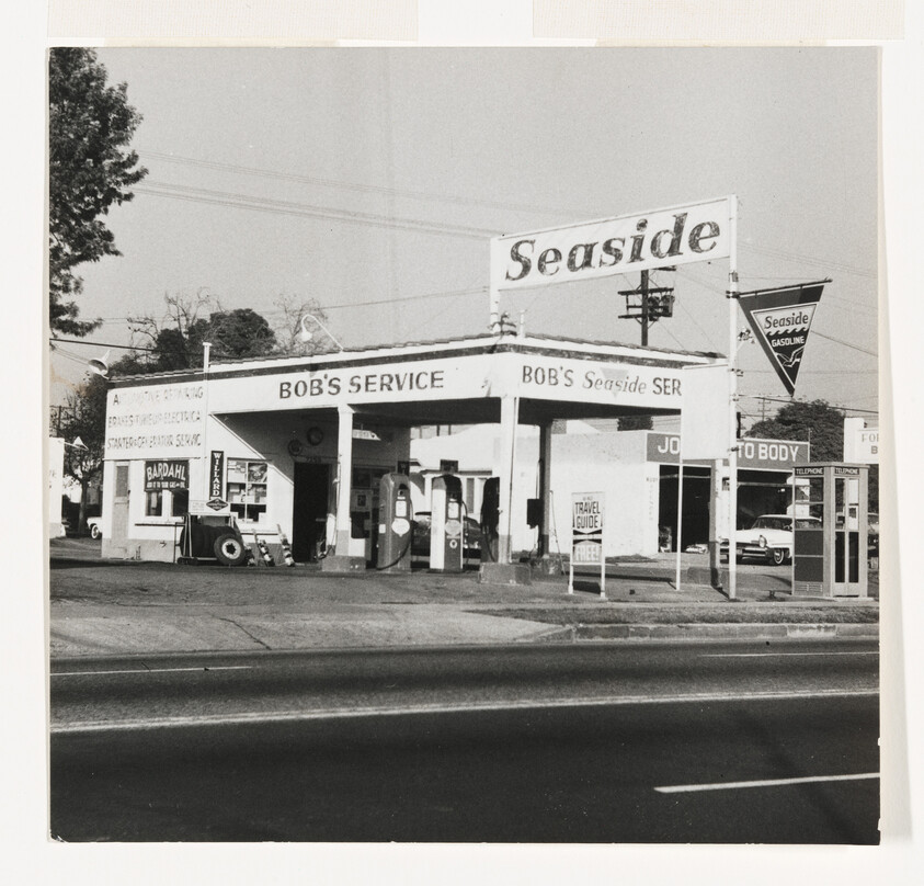 Bob's Service gas station with Seaside sign and vintage pumps at roadside.