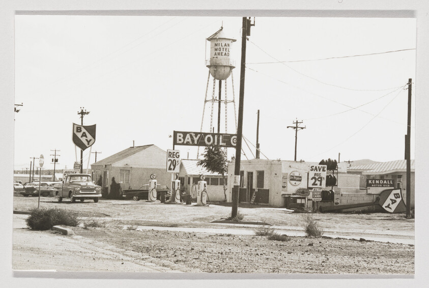 Vintage Bay Oil gas station with pumps and signs advertising regular gasoline for 29 cents.