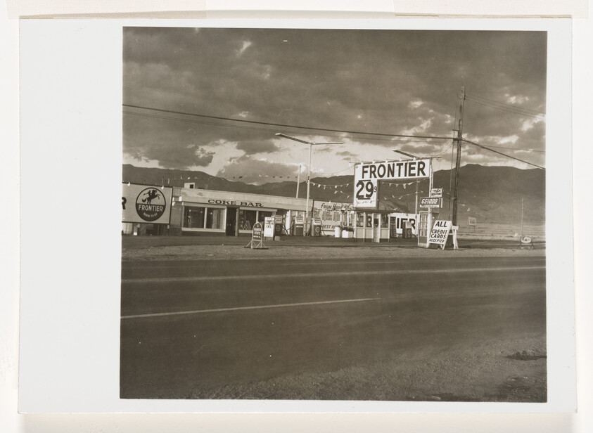 Frontier gas station with 29-cent price sign and adjacent coke bar.