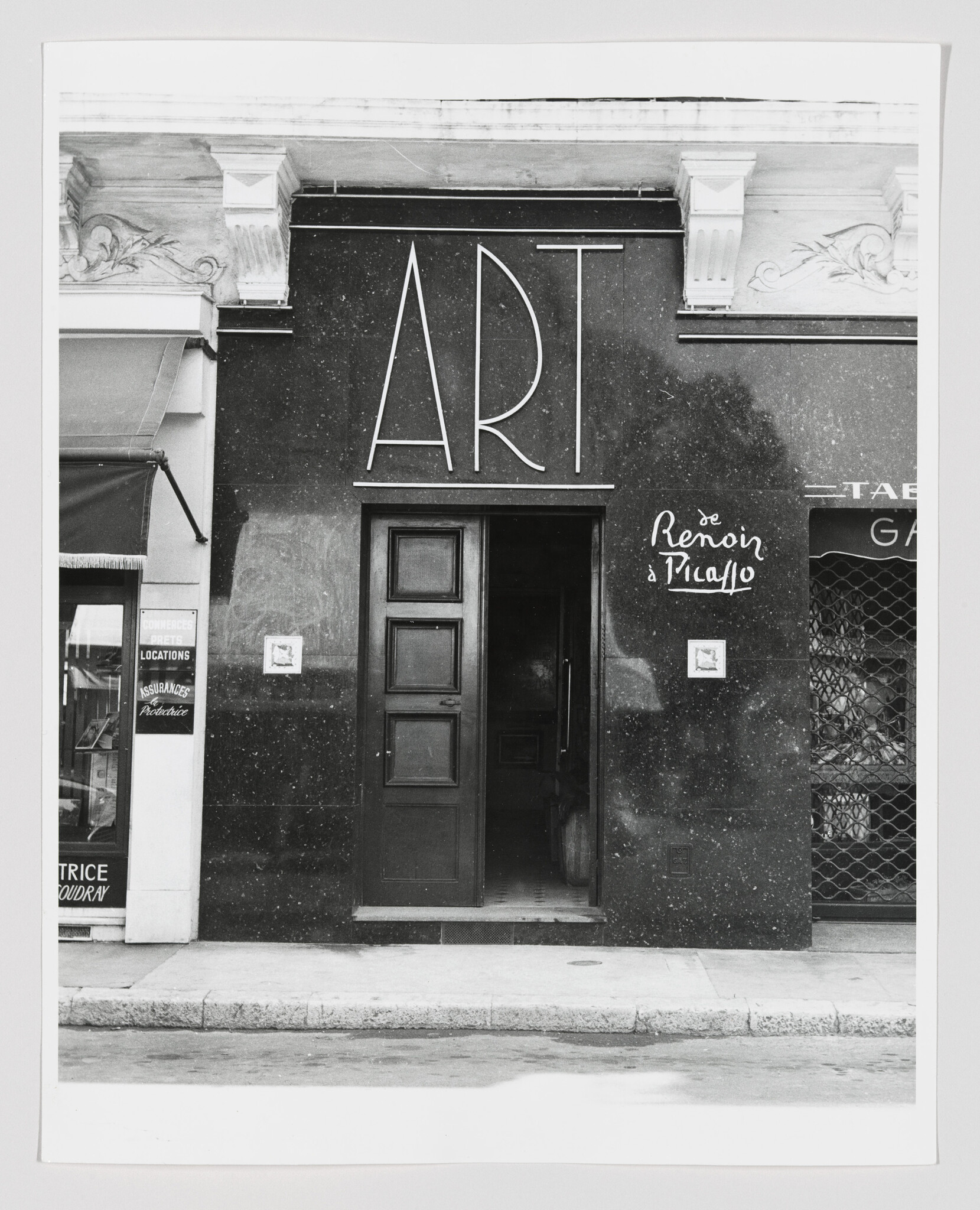 Black gallery entrance with large "ART" sign and an open doorway inviting visitors inside.