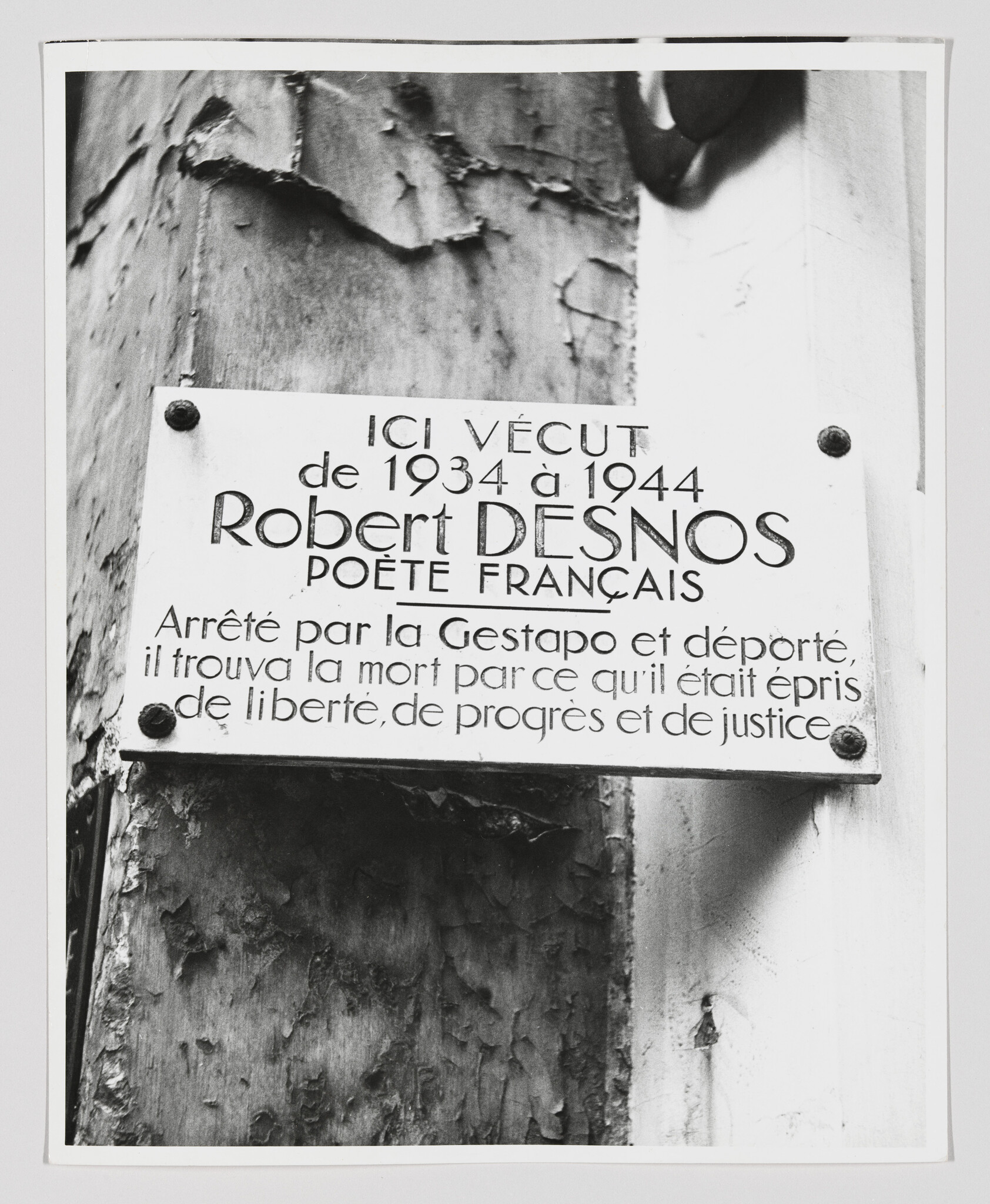 Commemorative plaque marking where French poet Robert Desnos lived and noting his arrest and deportation.