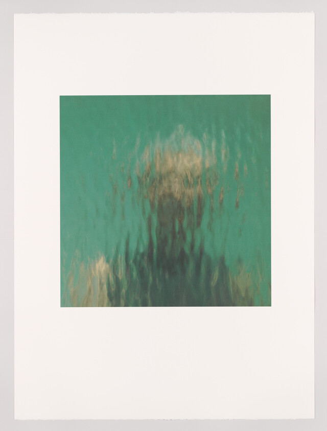 A framed abstract artwork featuring a blurred and ethereal underwater scene with a greenish-blue color palette, giving the impression of movement or the flow of water.