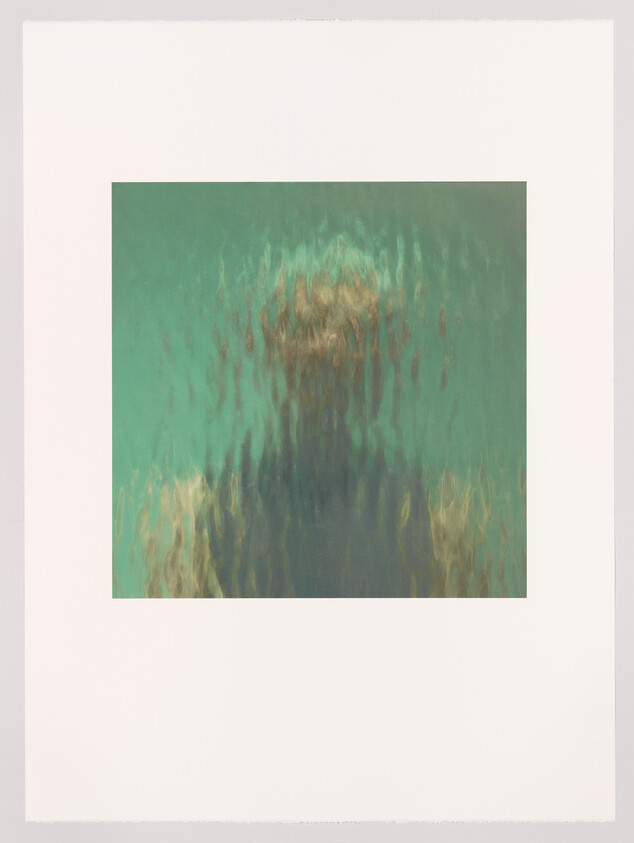 Blurry silhouette of a person seen through rippling glass or water, colors teal and gold.