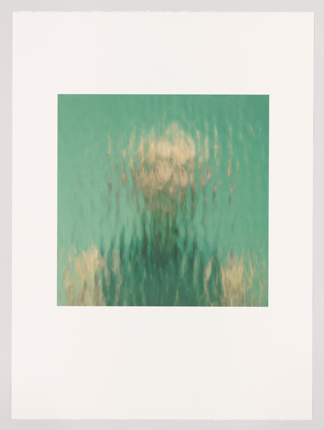 A blurred human silhouette appears behind rippled glass or water with green and gold tones.