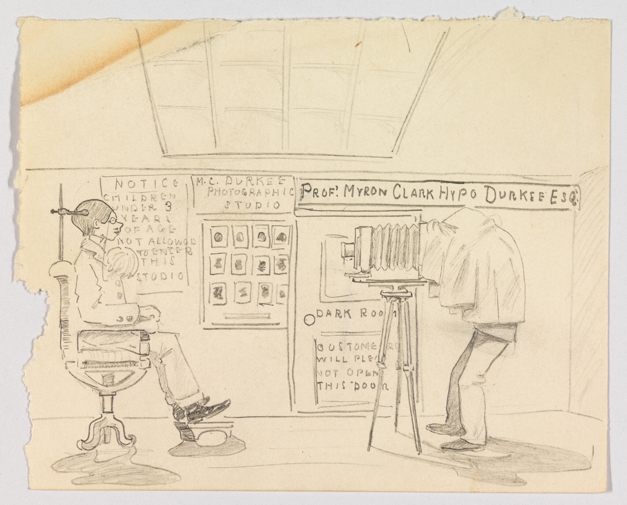 Man sits in chair being photographed by a photographer using a large covered bellows camera.