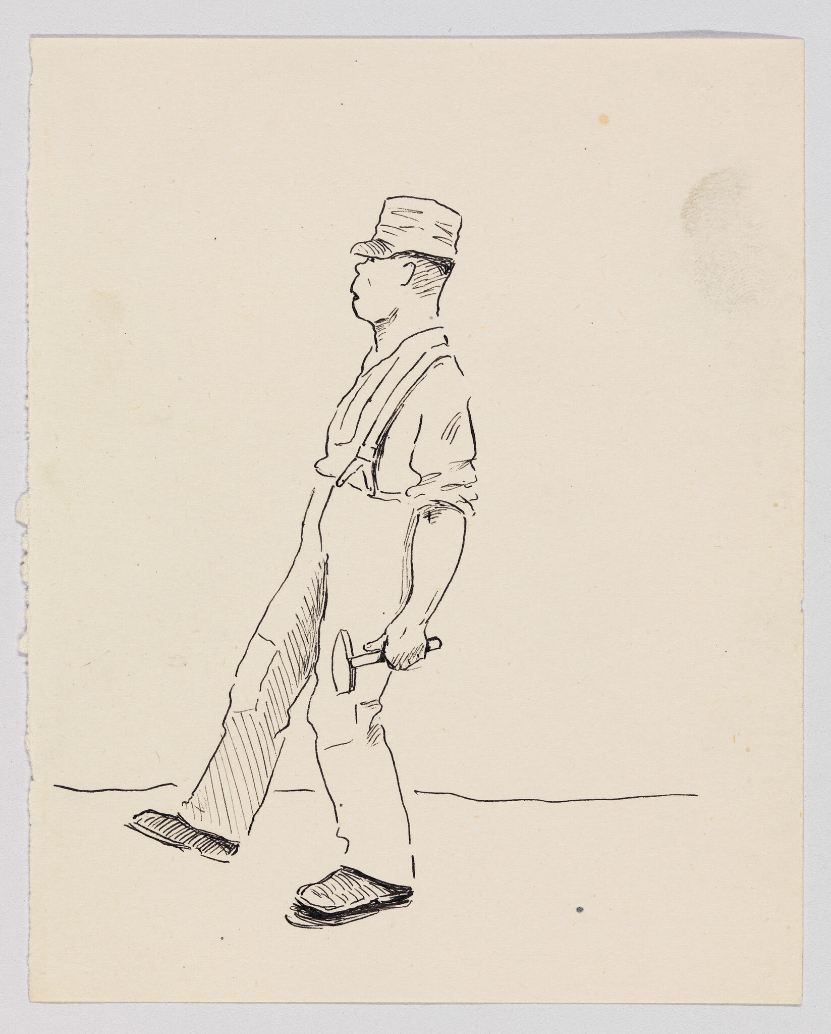 A man in a hat and suspenders walks while holding a hammer in his right hand.
