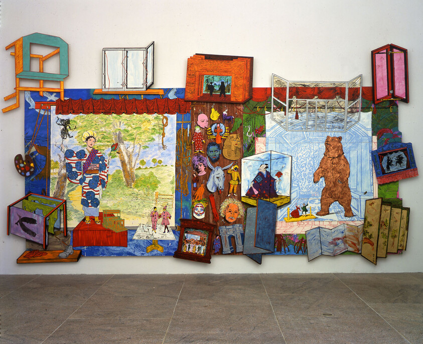 A large colorful wall collage features painted scenes, pop-out boxes, and a standing brown bear.