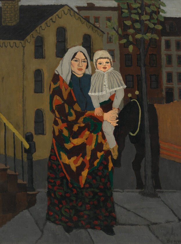 A woman wrapped in a patterned shawl holds a small child on a city sidewalk.