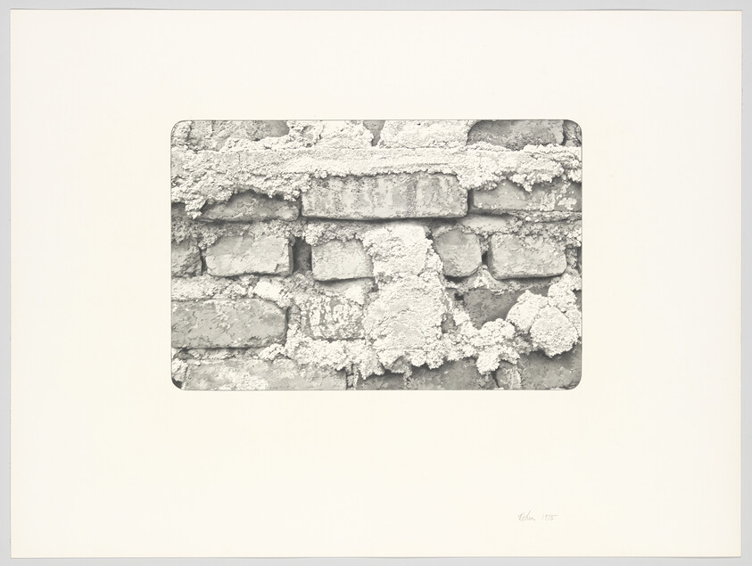 Close-up of an old brick wall with crumbling mortar and chunks of plaster falling away.