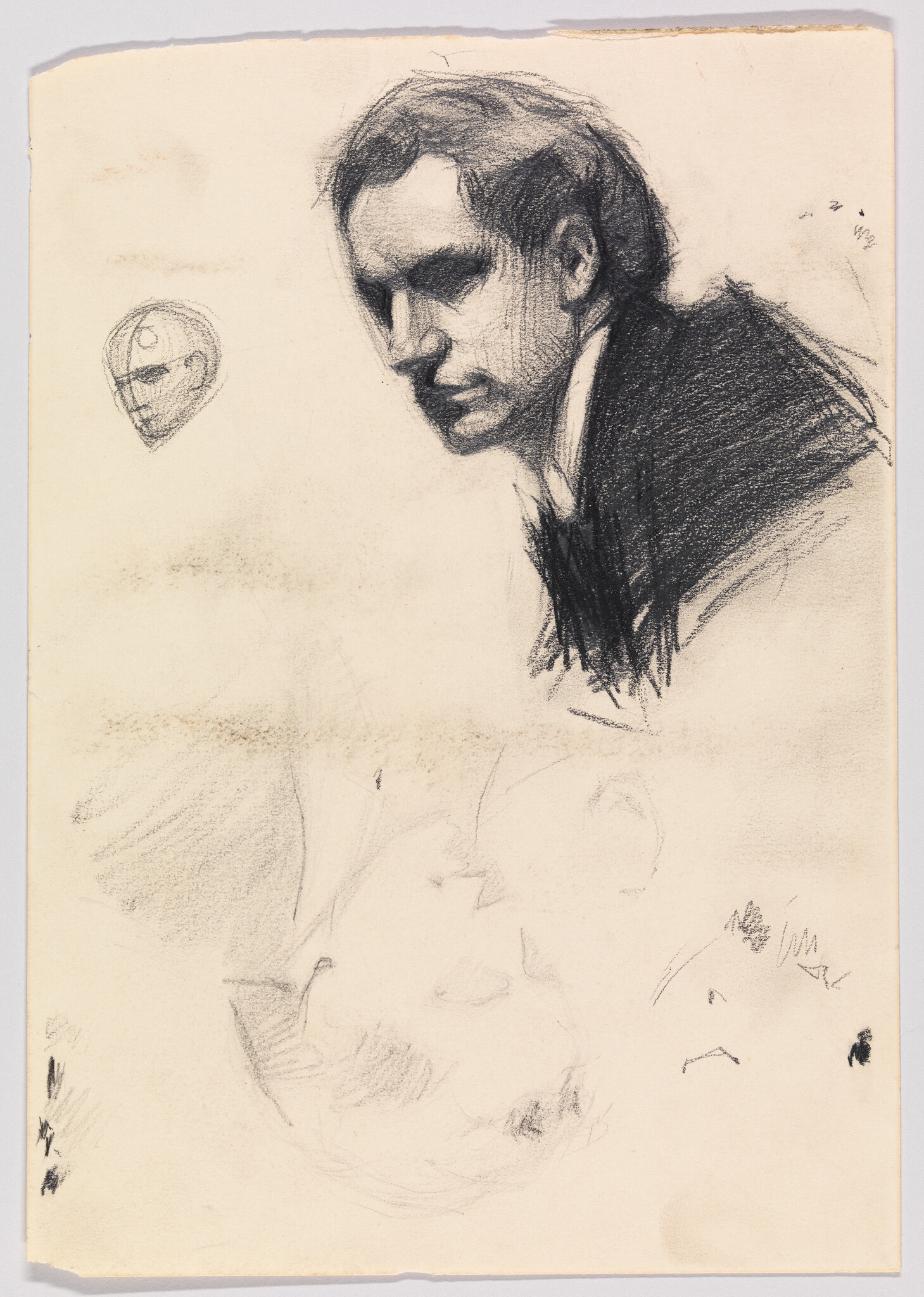 A charcoal sketch of a man in a suit looking downward, with a small head study nearby.