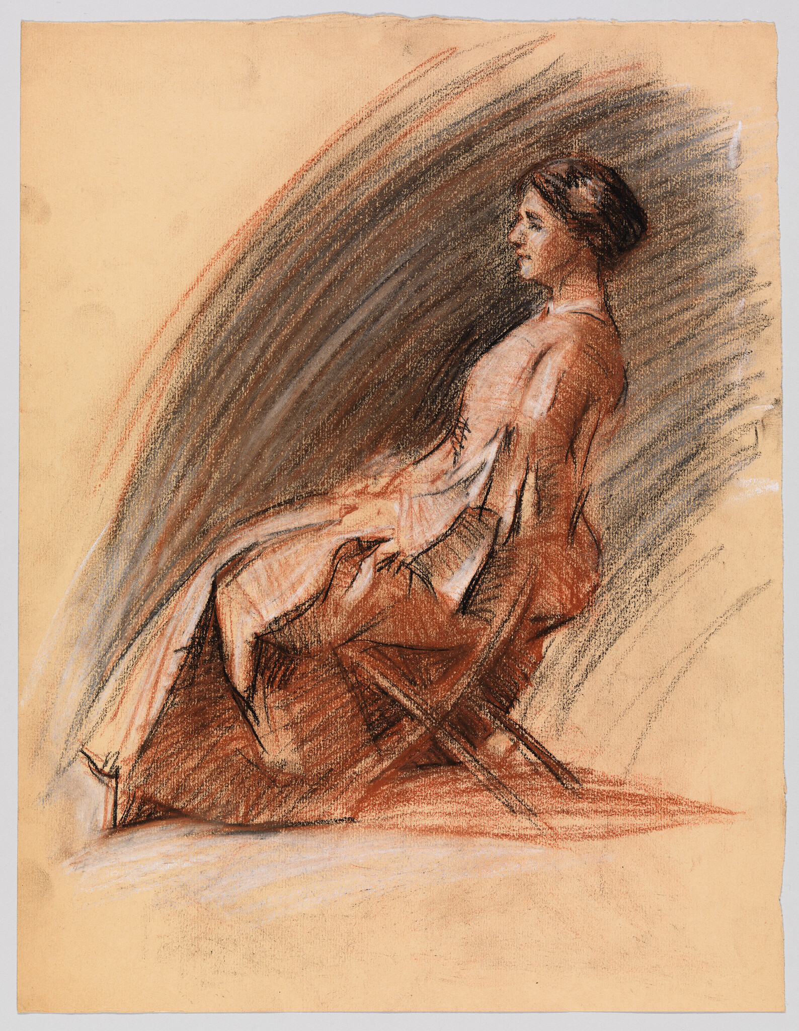 A seated woman in a long dress sits in profile with her hands resting in her lap.