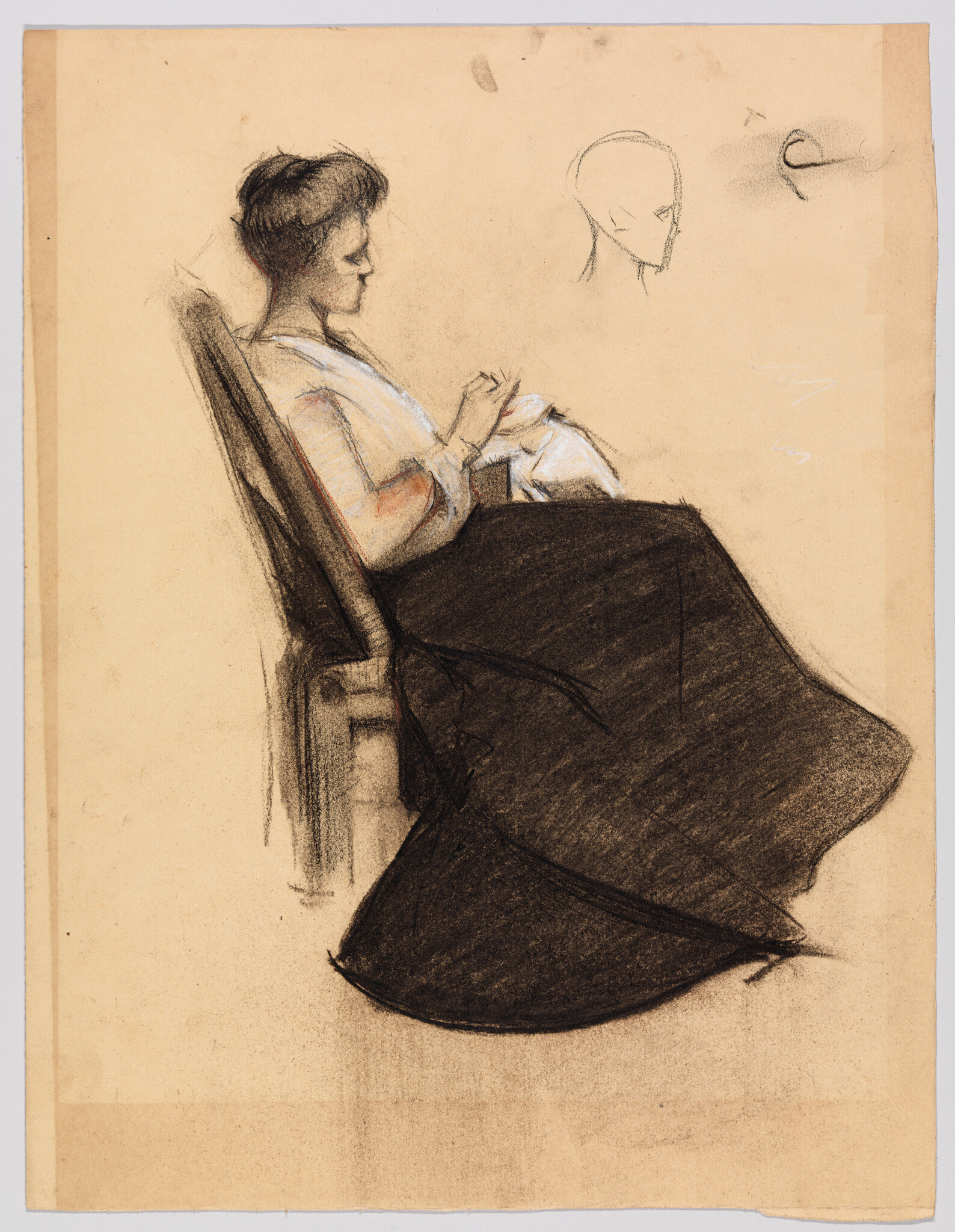 A seated woman in a long dark skirt quietly sewing or knitting with folded fabric in her lap.
