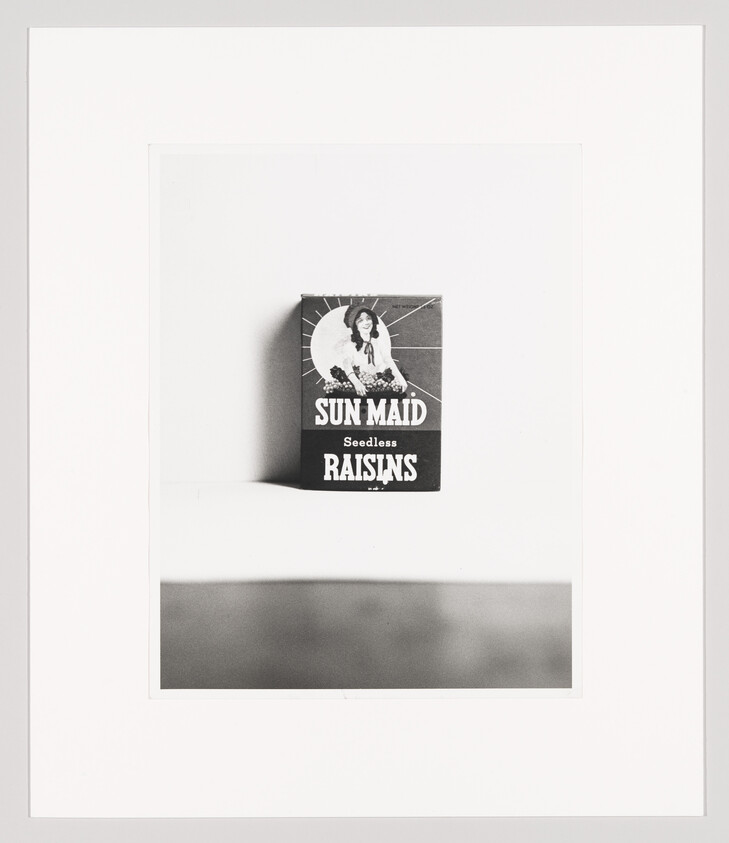 A Sun-Maid seedless raisins box centered on a white background casting a shadow.