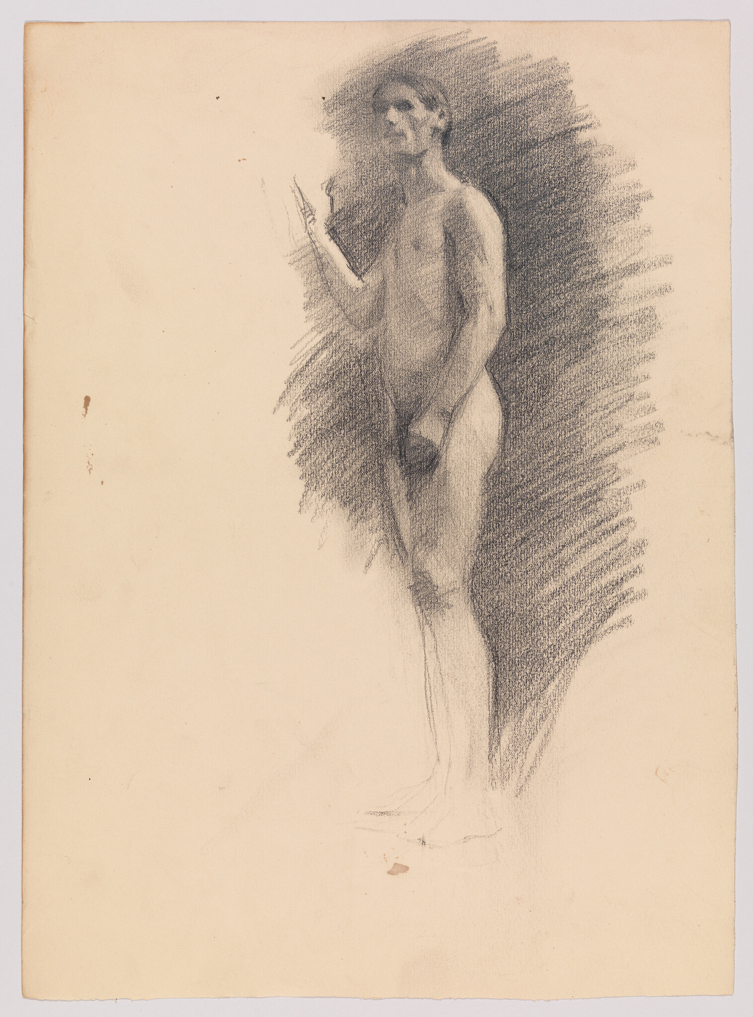 Standing charcoal sketch of a nude man with one hand raised and shaded background.