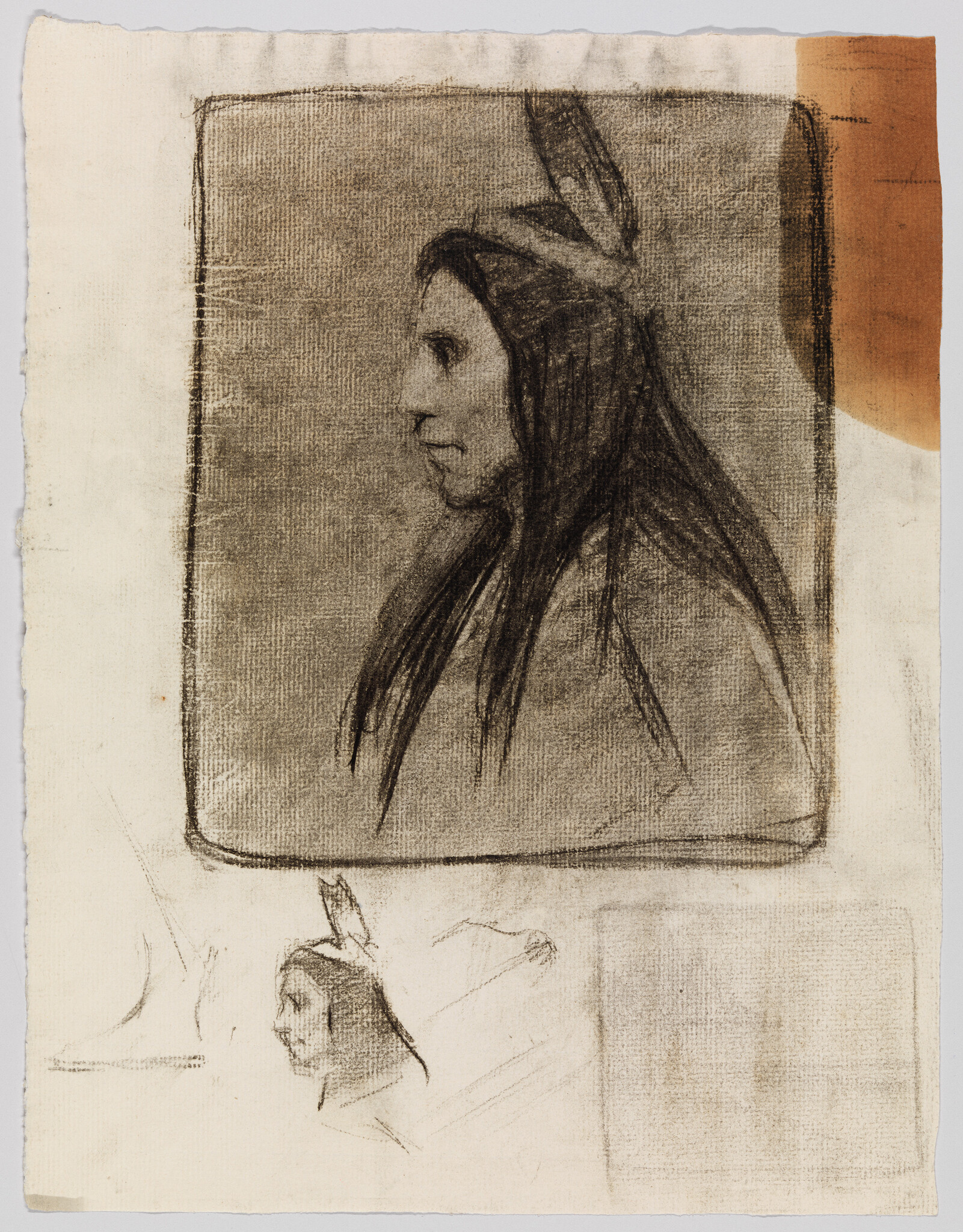 A sketch of a person's profile with long hair and a feather, with additional faint sketches visible on the canvas. The background includes a large, plain square and a smaller square with a reddish-brown stain on the upper right corner.