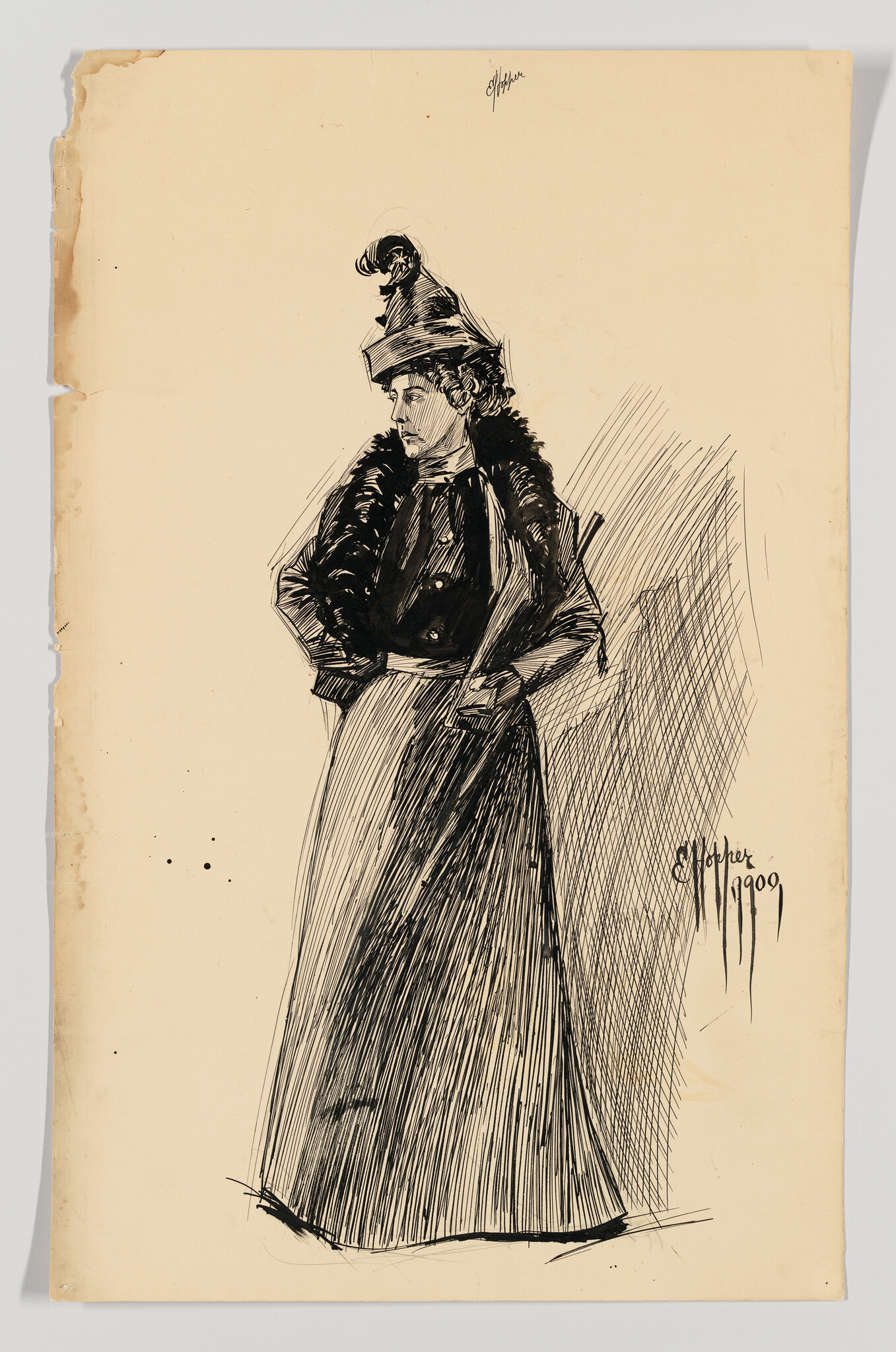 A woman in a long skirt and fur-collared coat wearing a tall hat stands with hands on hips.