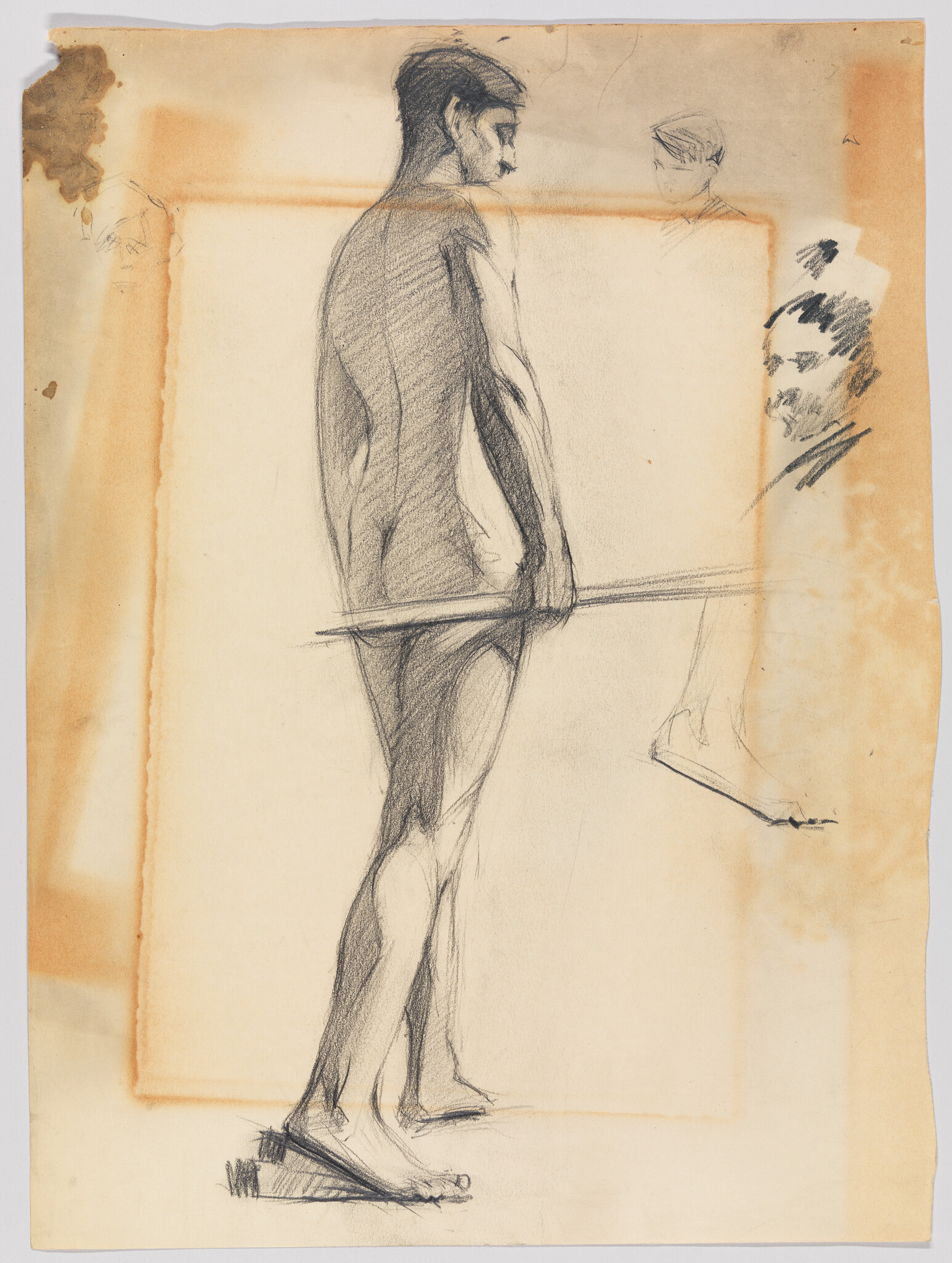 Standing nude man sketched in charcoal, seen from behind holding a long pole.