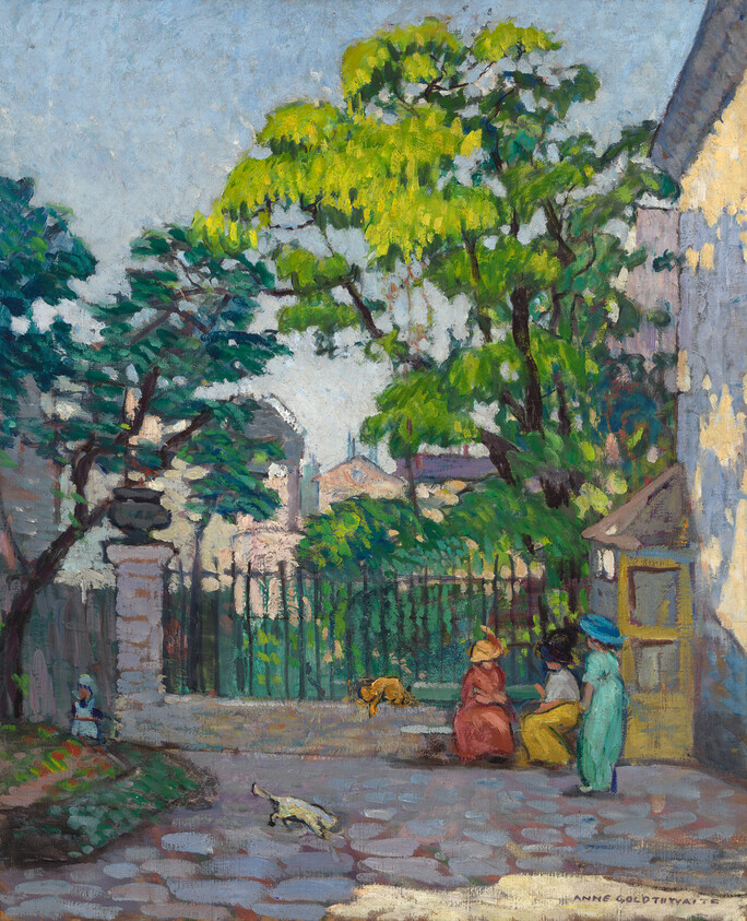 Three women sit and talk near a gate under large trees while cats wander on the cobblestones.
