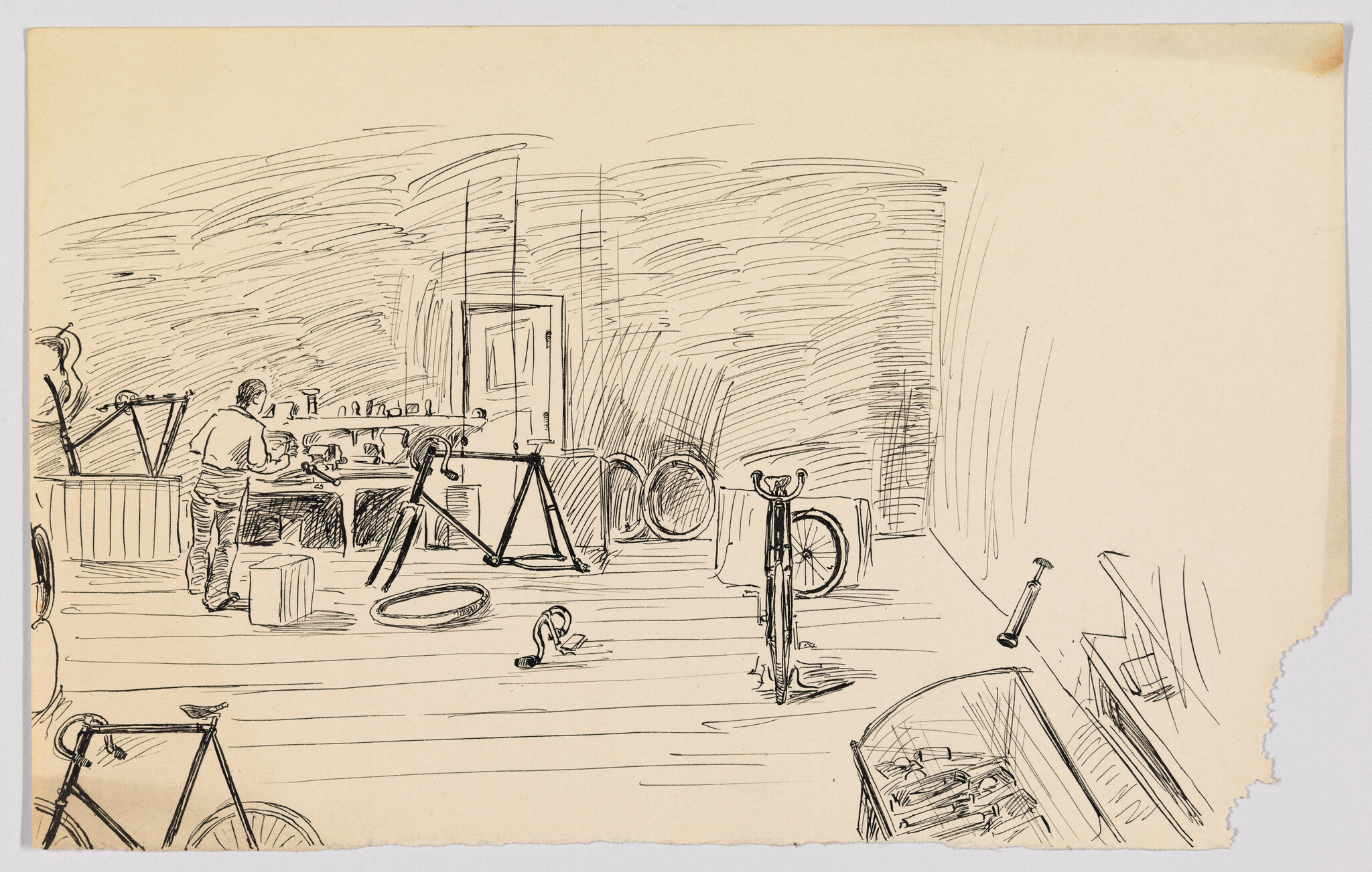 A man at a workbench repairs bicycle parts surrounded by frames, wheels, and tools.