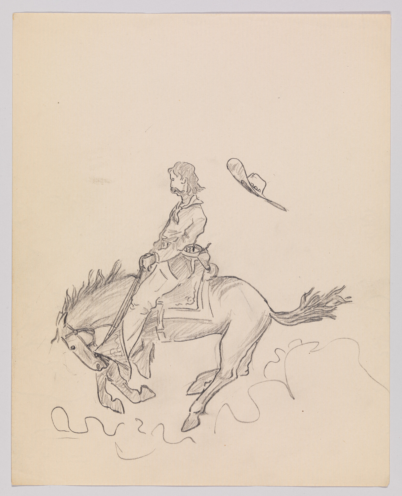 A rider sits on a rearing horse as his hat flies off into the air.