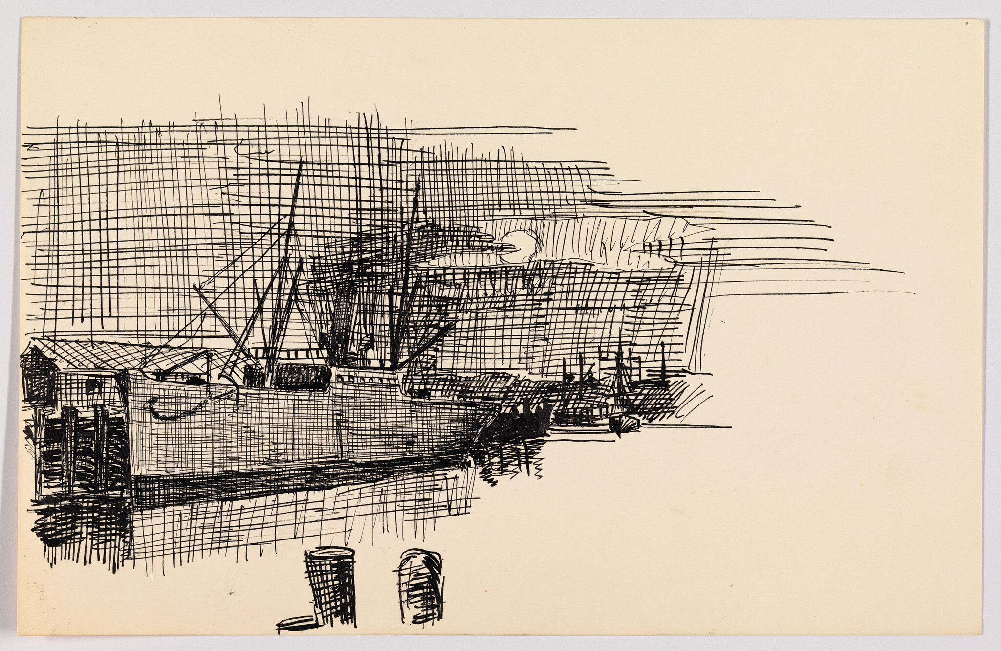 Ships and boats moored at a dock with visible masts and calm water reflections.