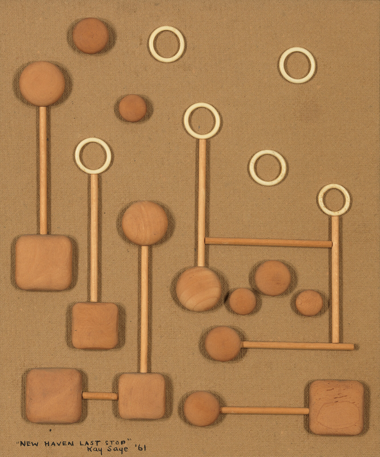Several wooden circles and squares connected by thin dowel rods arranged on a tan fabric background.
