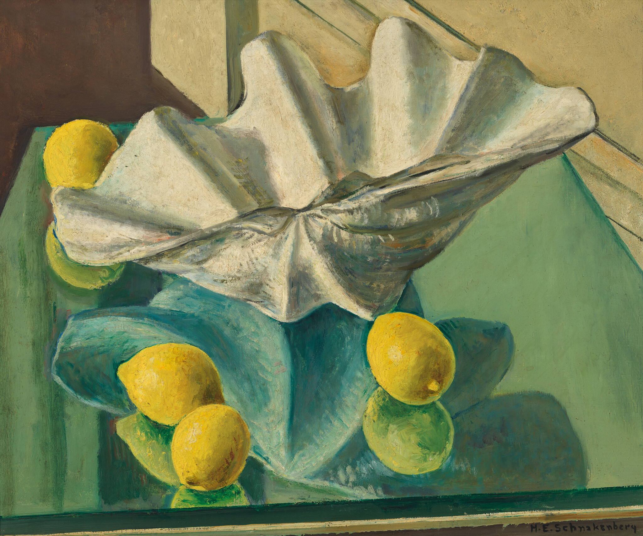 A white draped cloth rests on a teal reflective surface surrounded by four yellow lemons.