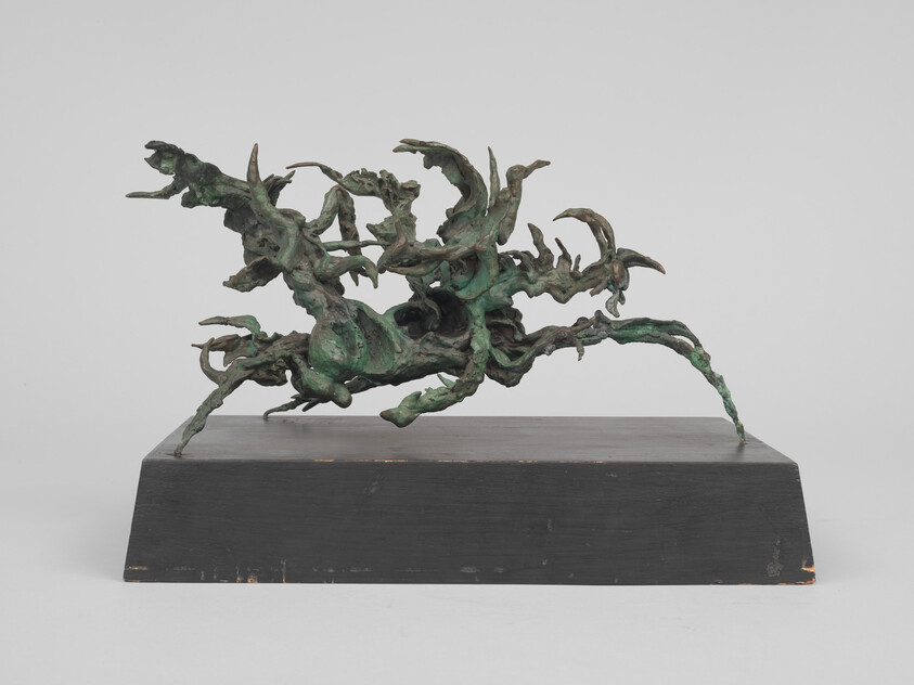 Abstract green bronze sculpture with twisting, claw-like forms mounted on a rectangular black base.