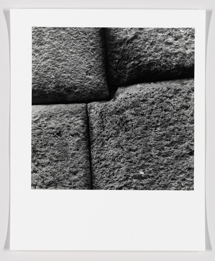 Rough, tightly fitted stone blocks showing textured surfaces and narrow mortarless joints.