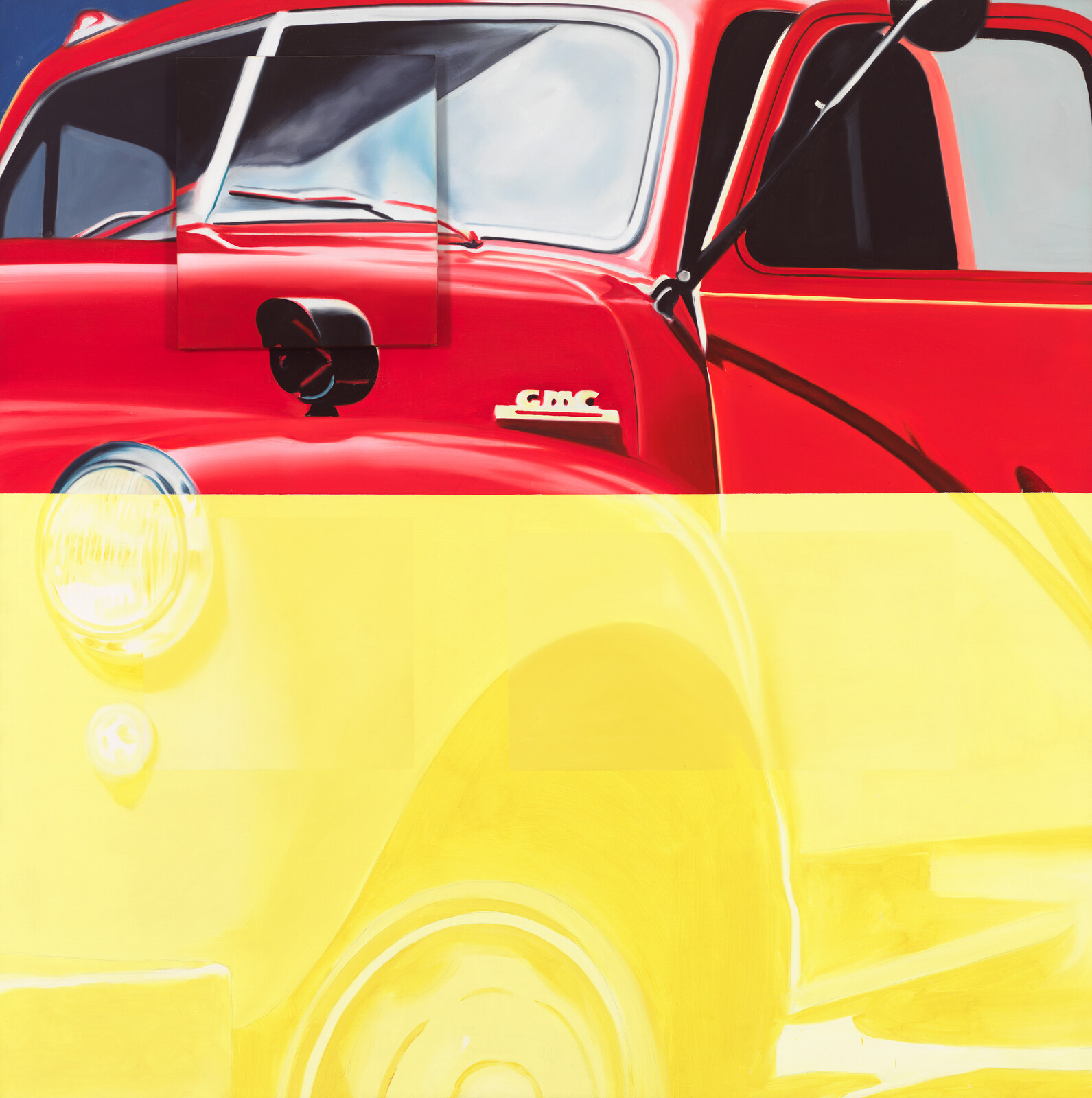 A red GMC truck front and fender with bold yellow color blocking.