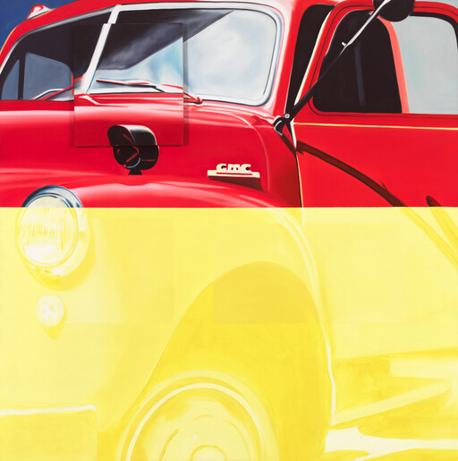 A red GMC truck front and fender with bold yellow color blocking.