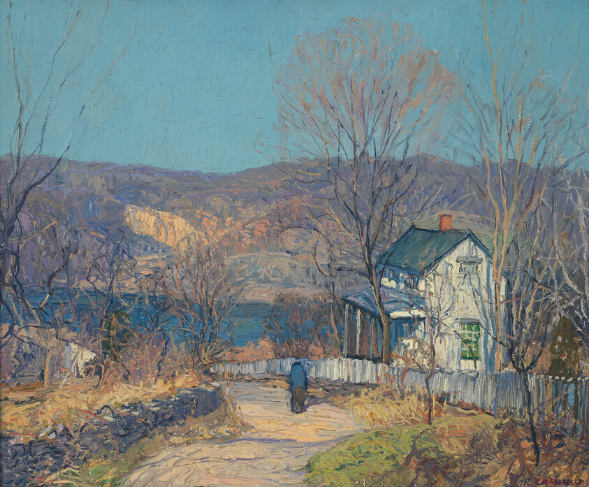 A person walks down a dirt path past a white house with a fence, surrounded by bare trees and hills.