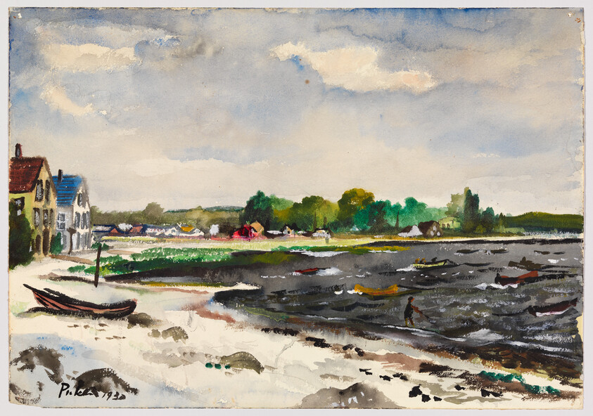 A coastal village with boats on a sandy shore and a person wading in choppy water.