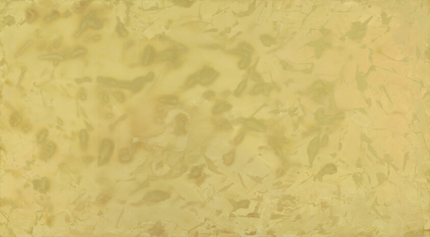 A worn yellowish parchment paper background with mottled stains and subtle creases.