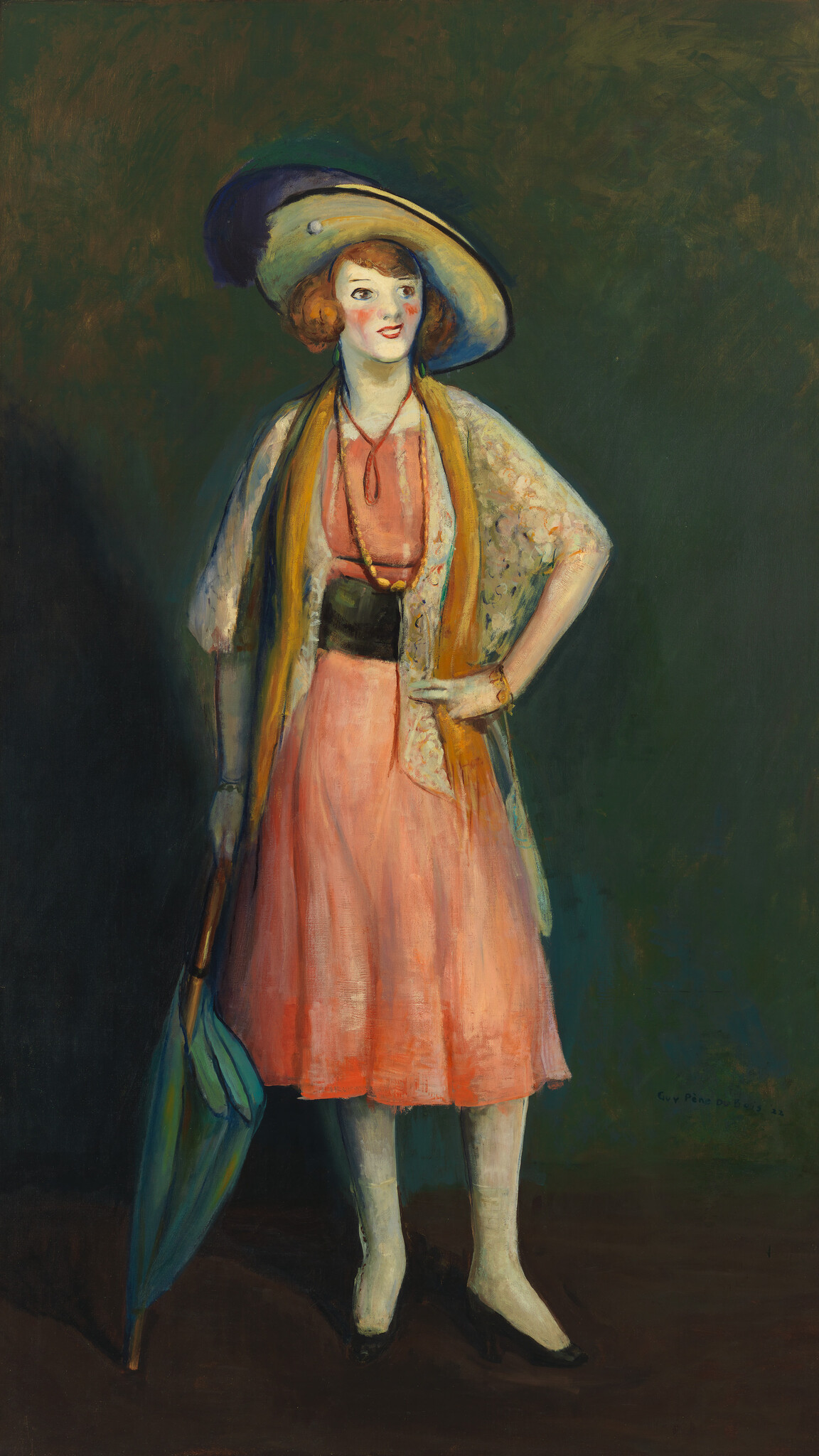 A woman wearing a wide hat and pink dress stands holding a closed blue umbrella.