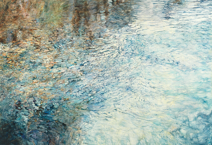 Shimmering blue water with gentle ripples and colorful stones visible beneath the surface.