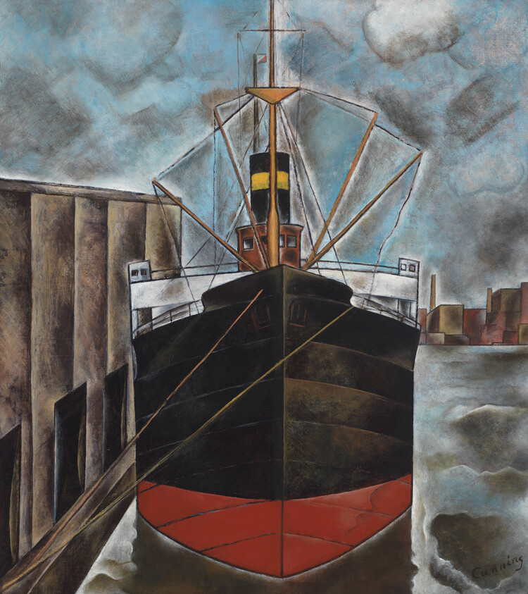 A large black and red cargo ship docked at a pier under a cloudy sky.