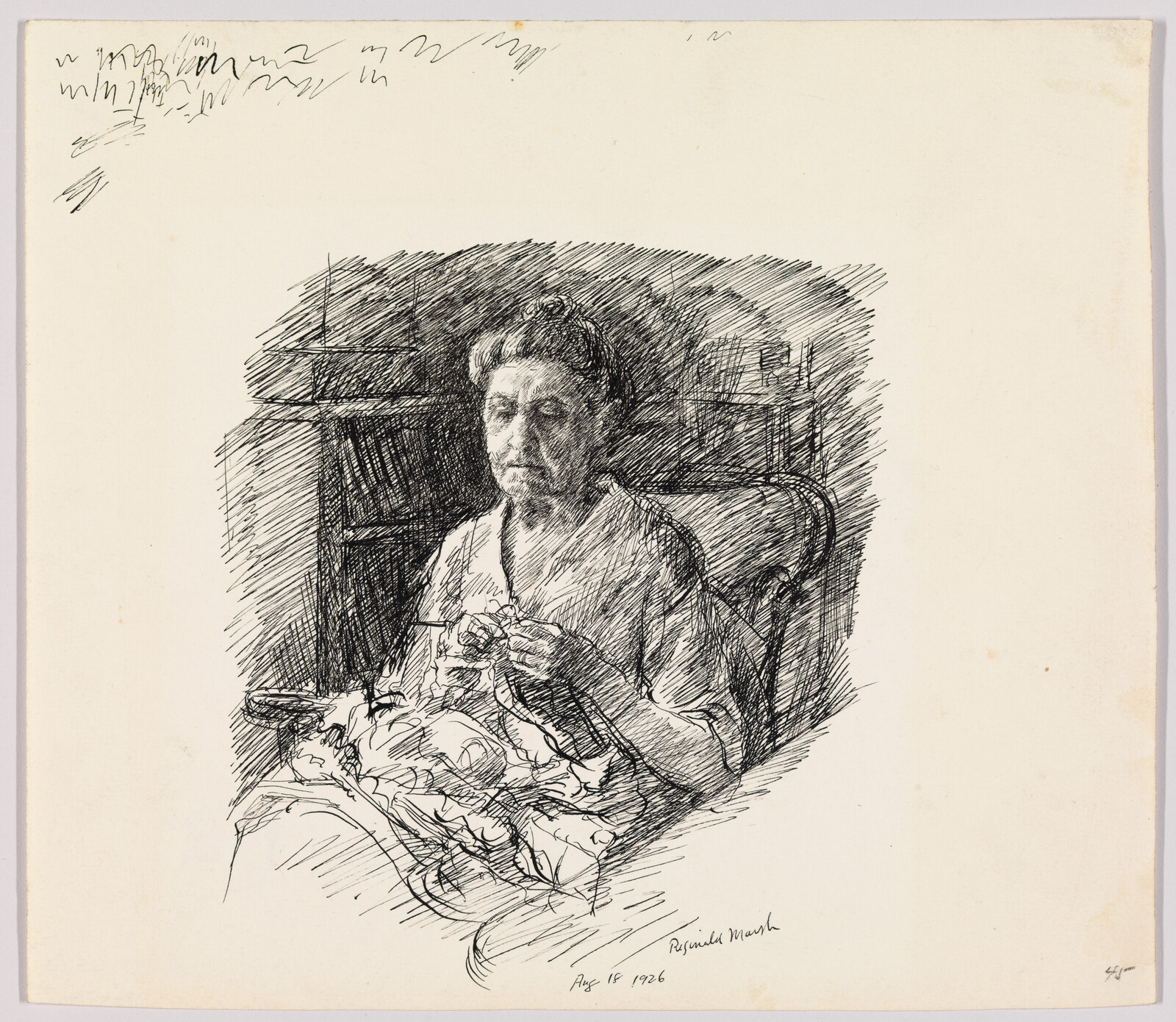 An older woman sits in a chair knitting with a pile of fabric on her lap.