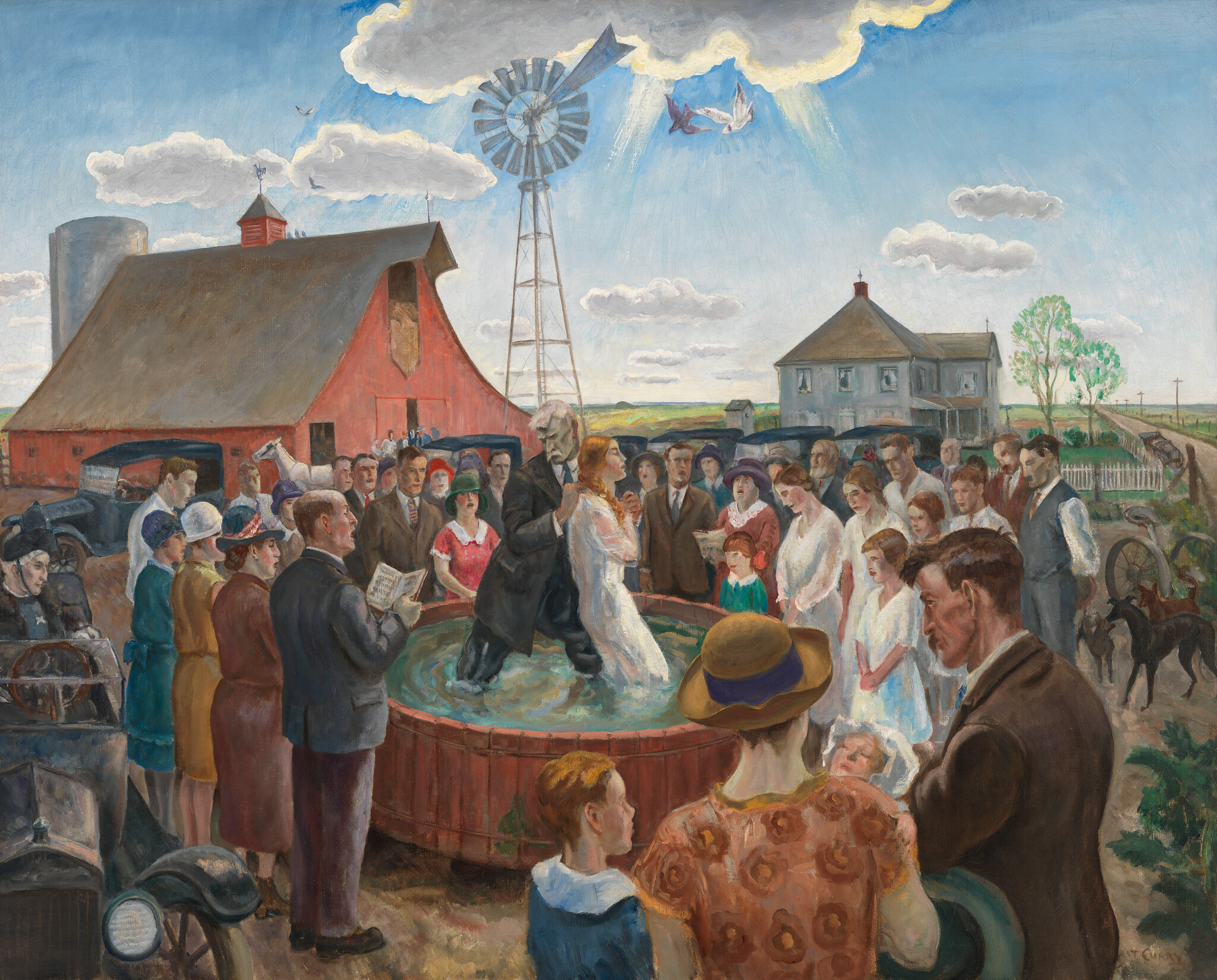 A minister baptizes a young woman in a wooden tub while a large crowd watches on a farm.