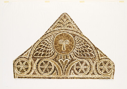Triangular carved panel showing a stylized sun face, wings, and circular star rosette decorations.